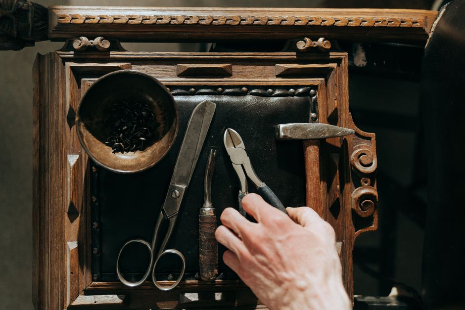 A selection of vintage tools on a wooden table, perfect for renovation and crafts.